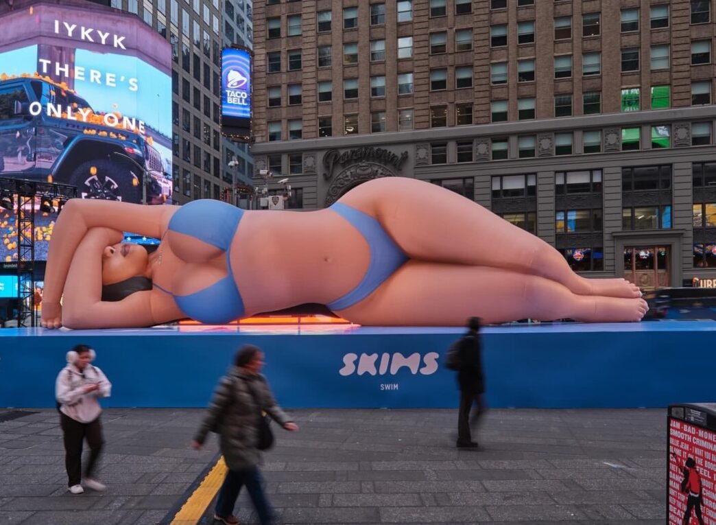 Kim Kardashian Promotes Skims Swim with a Blue Bikini Clad Blow Up Doll in Times Square