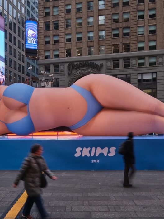 Kim Kardashian Promotes Skims Swim with a Blue Bikini Clad Blow Up Doll in Times Square